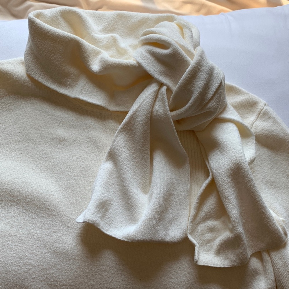 Ann Taylor Loft cream turtleneck sweater with tie detail.